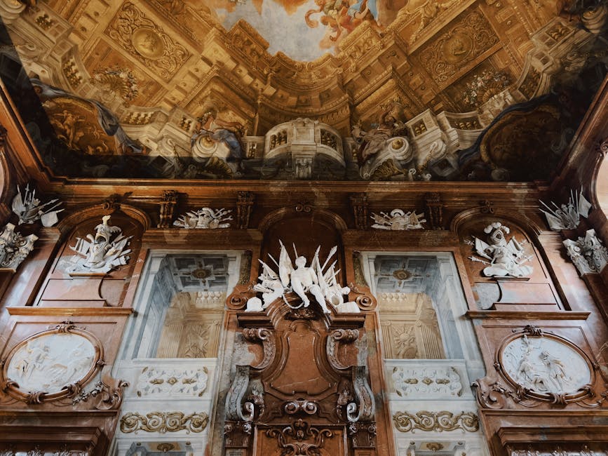 A detailed view of a Baroque interior with intricate ceiling art and sculptures.