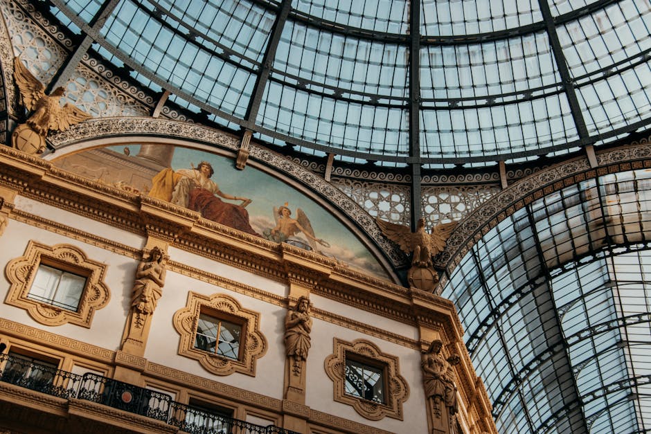 Detailed view of a historic building's ornate decoration beneath a glass ceiling.